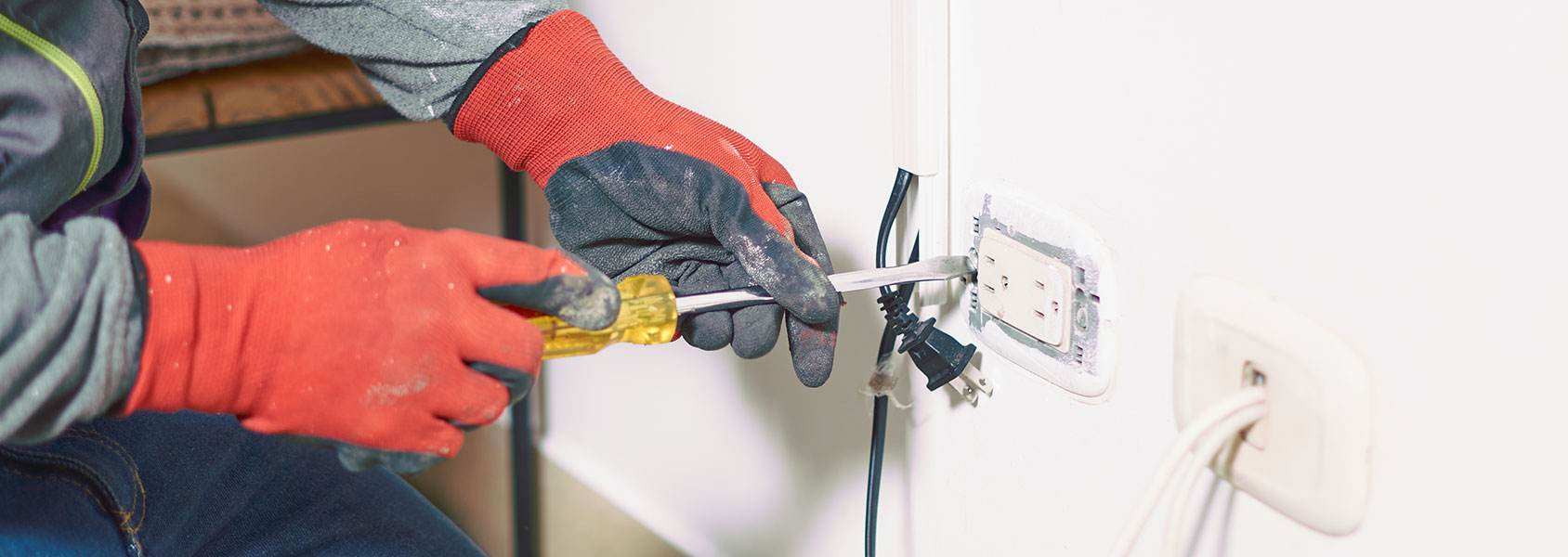 Electrician Working On Outlet